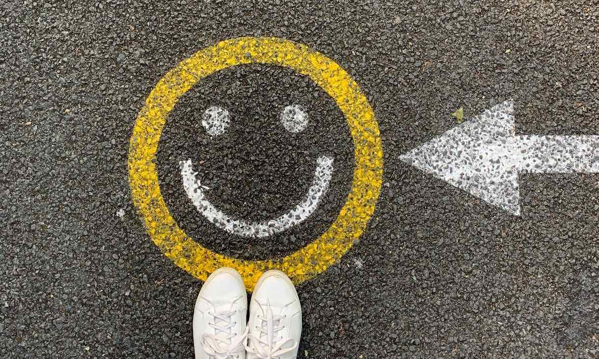 A smiley face painted on a road.