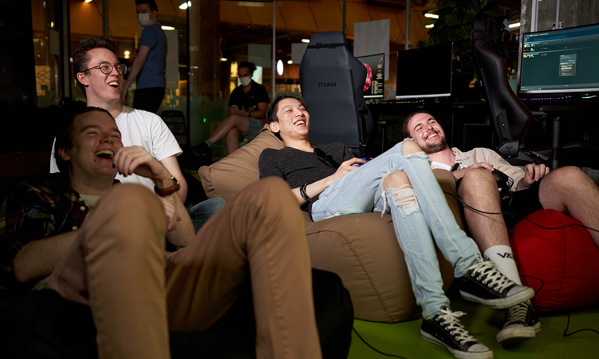 Students in a lounge playing video games