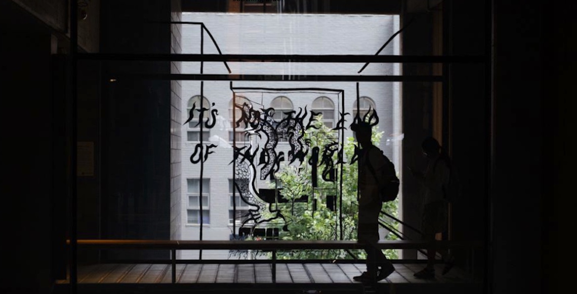 Silhouette of person in front of a window with text that reads 'It's not the end of the world.'