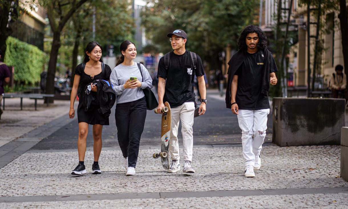 Four international students walking in a line
