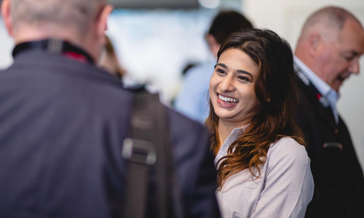 Woman smiling and talking to a man in a suit