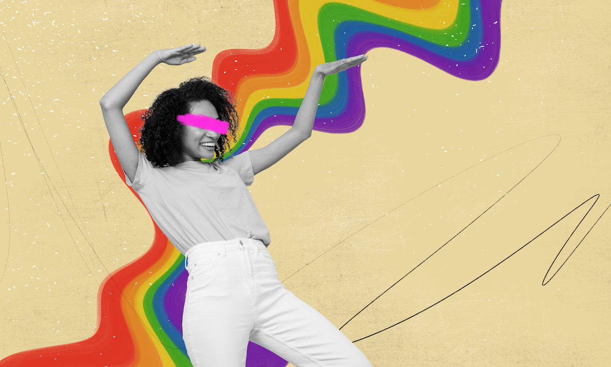 A person posing against a rainbow swirl