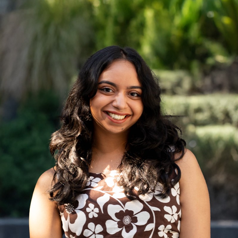 Person smiling at camera standing in garden