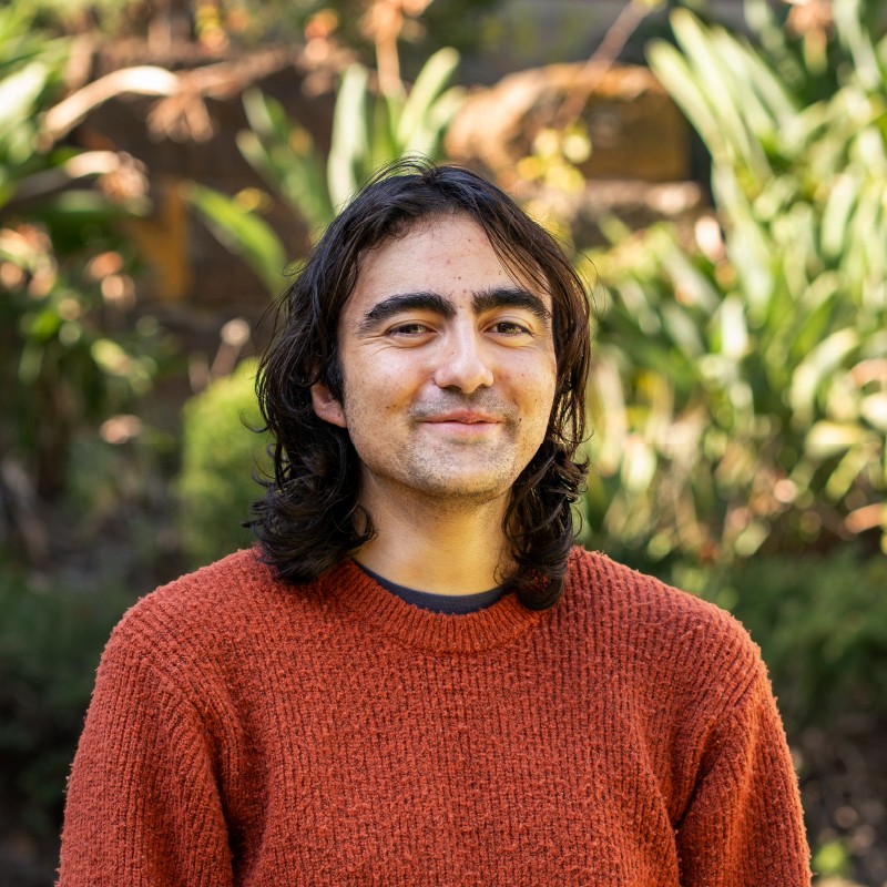Person with long hair smiling at camera