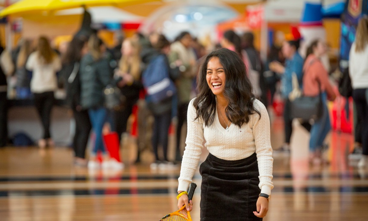 Person smiling playing tennis