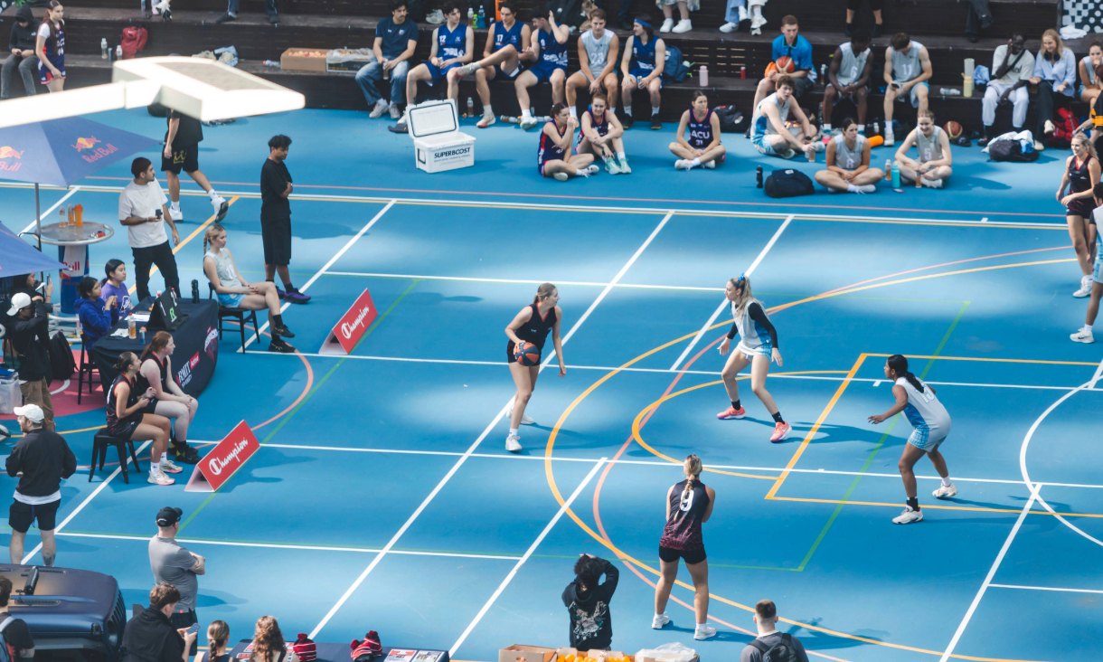 People playing sport on basketball court