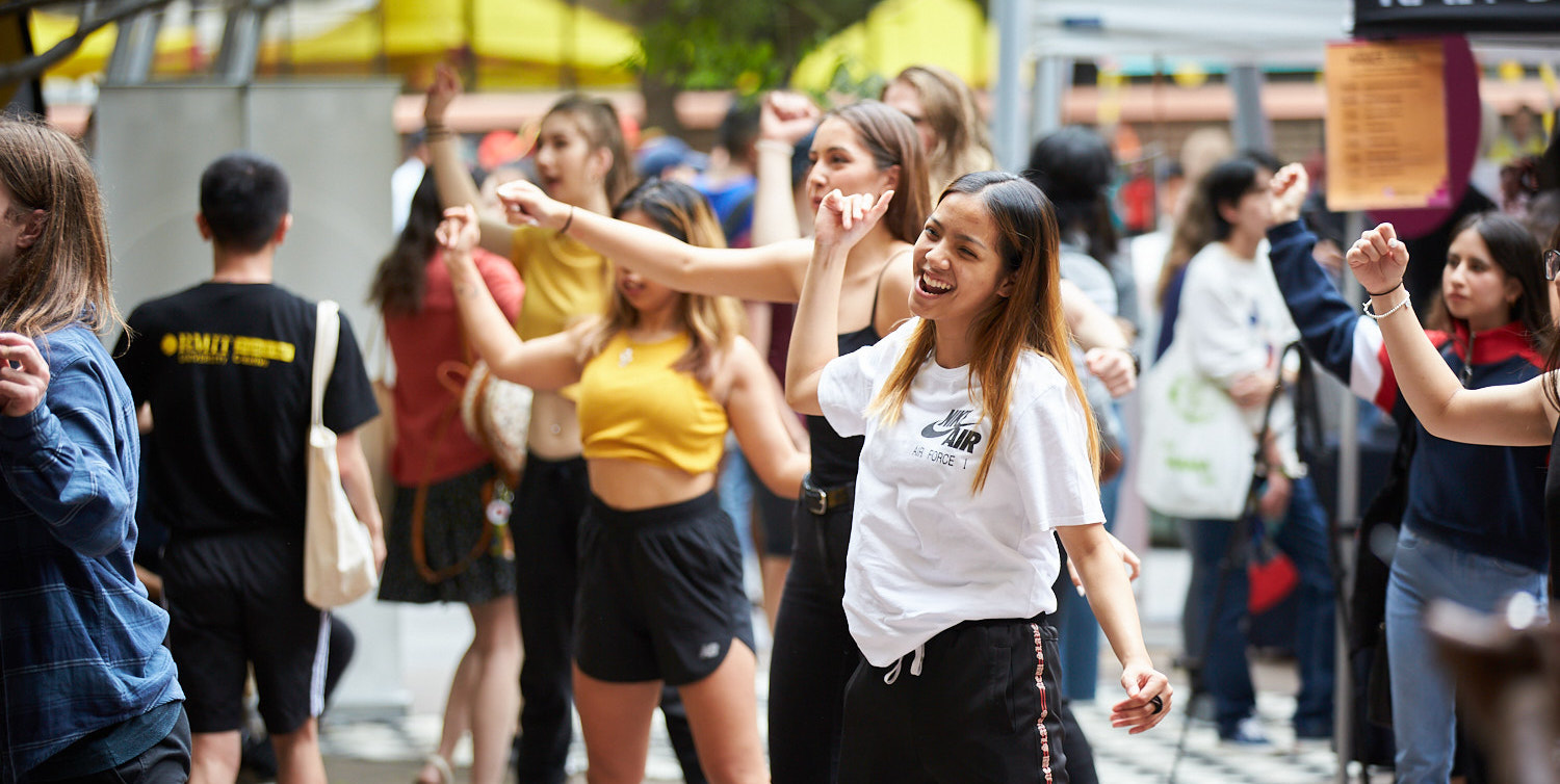 Students dance at an event at the City Campus.