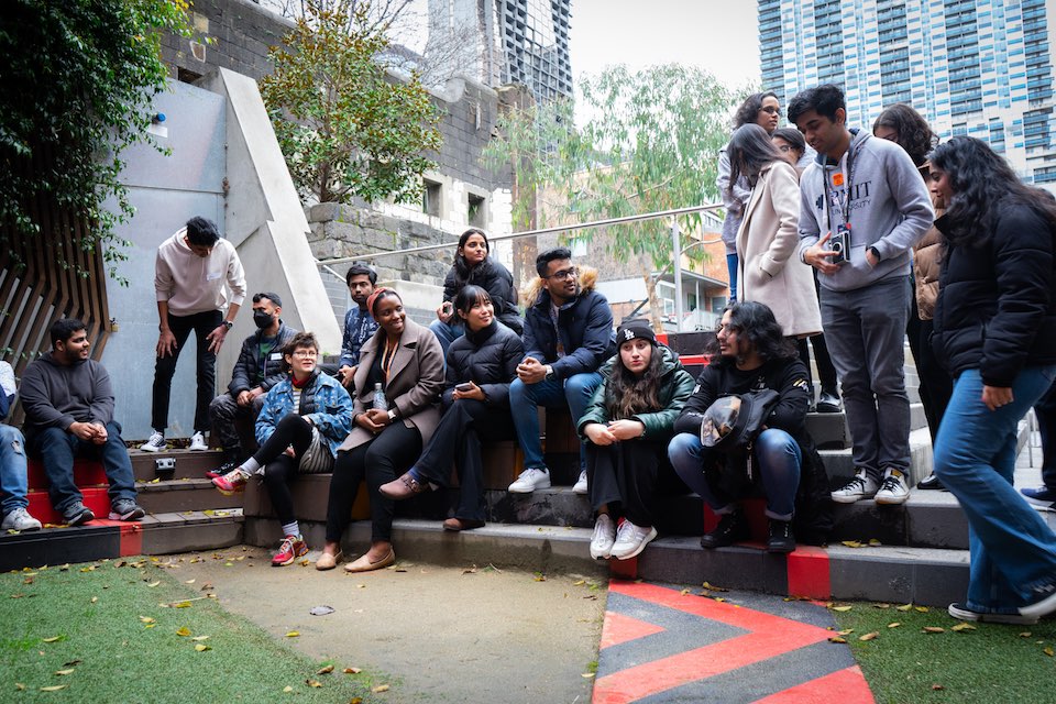 Students sitting in Ngarara Place Garden at City campus.