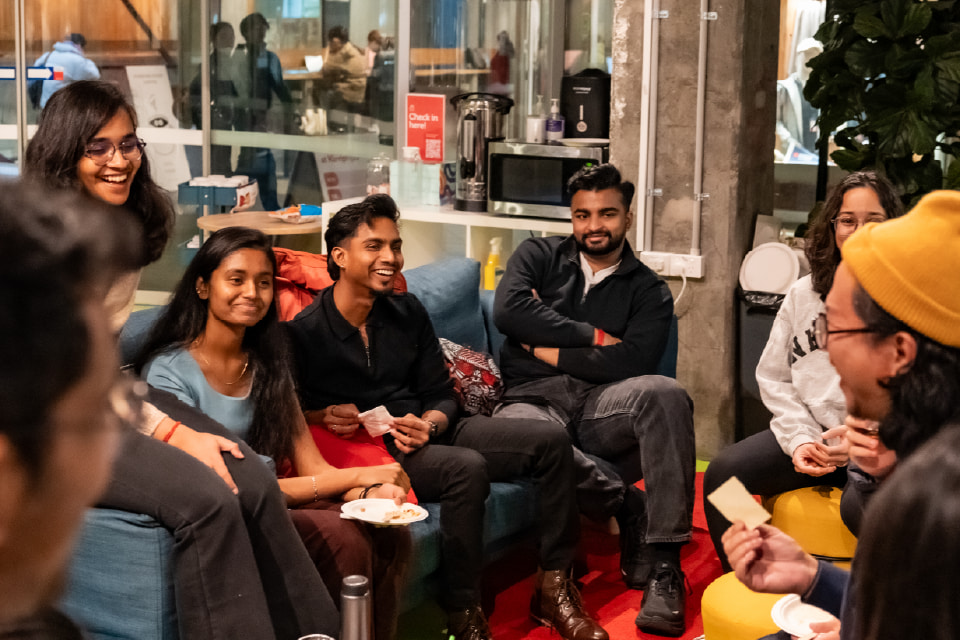 Students sitting on a couch listening to eachother