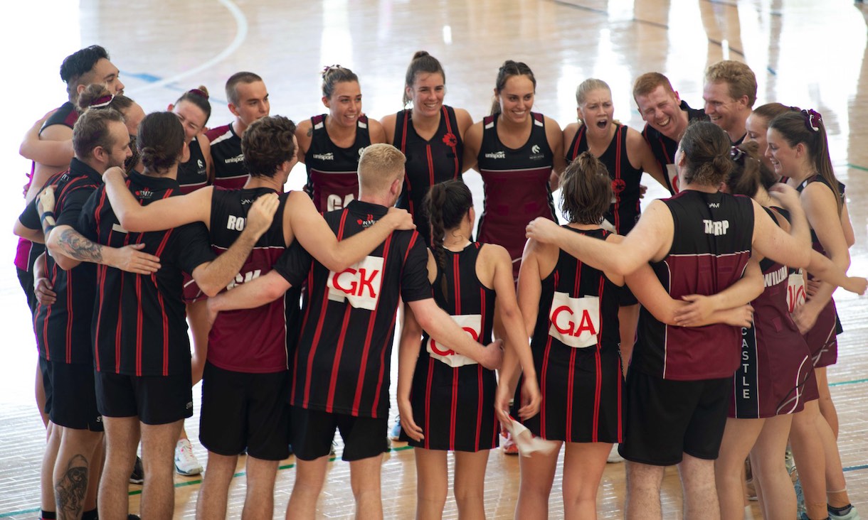 RMIT netball team in a huddle.