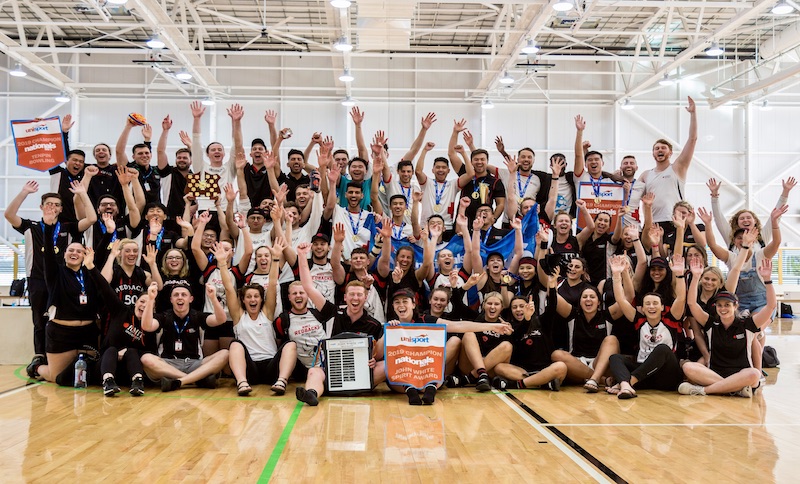 The RMIT Nationals team pose for a group shot in a gym.