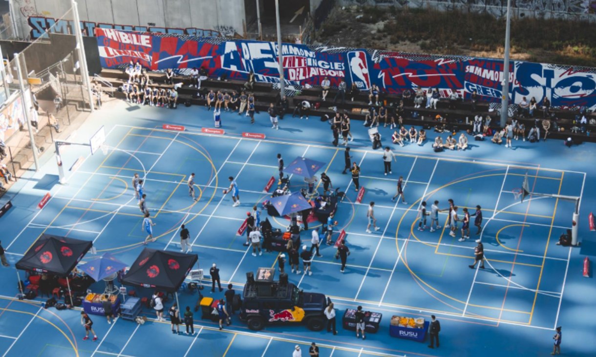 People standing around basketball court