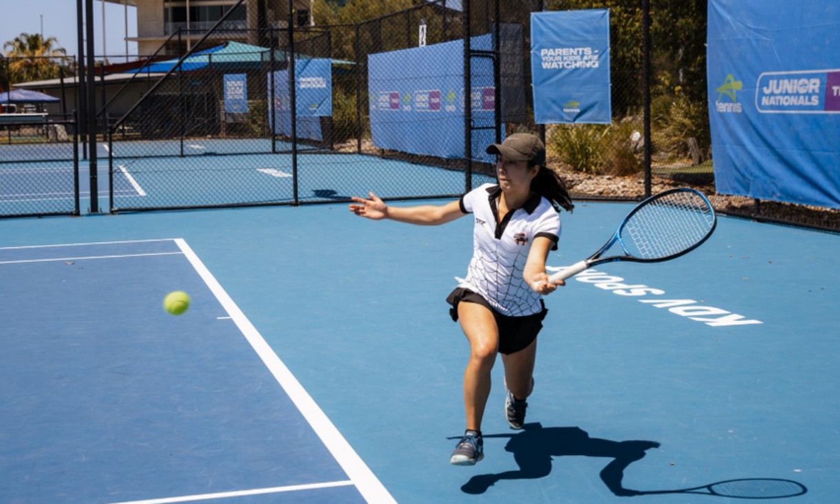 Person playing tennis on court