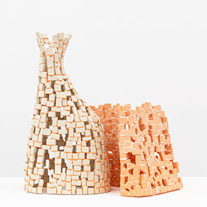 An artwork made of small, connected pieces of porcelain, with gaps between the pieces.