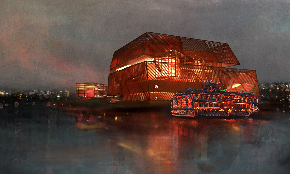 A large building at dusk is lit up with orange lights and sits along a river