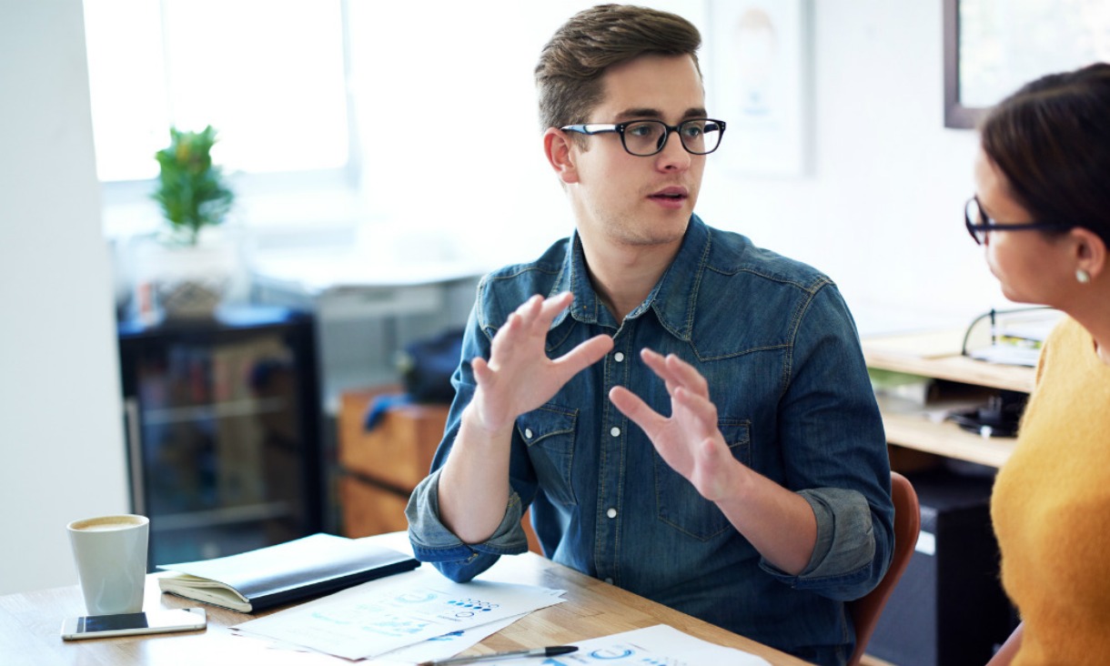 An accounting student discusses his work with his accounting teacher.