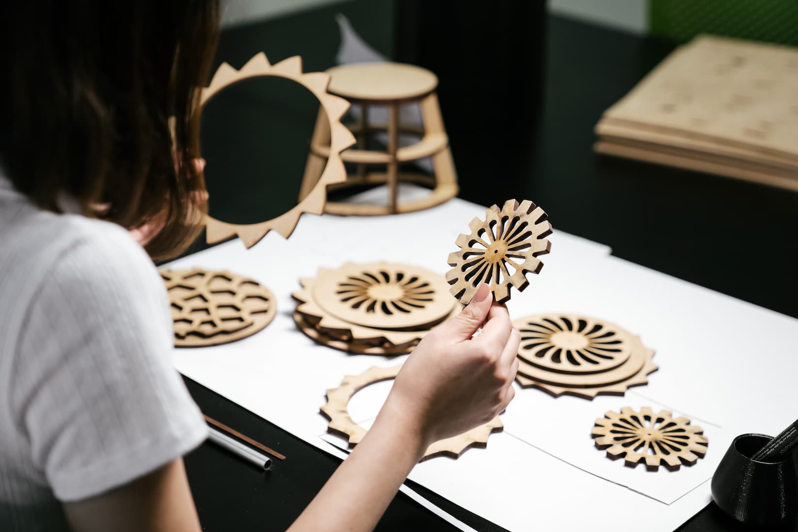 Student examining wooden cogs and wheels
