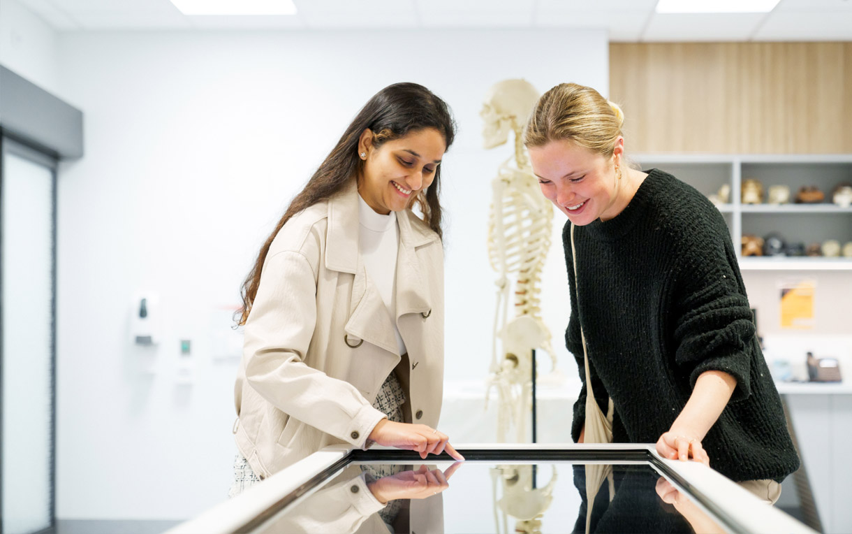 Two students standing over an Anatomage Table in the RMIT Bundoora Medical Labs 