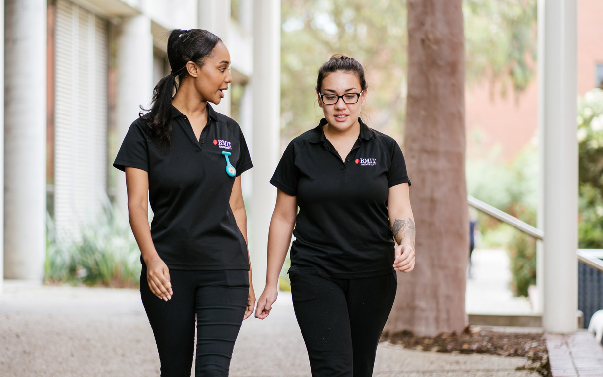 A pair of RMIT nursing students walking side-by-side