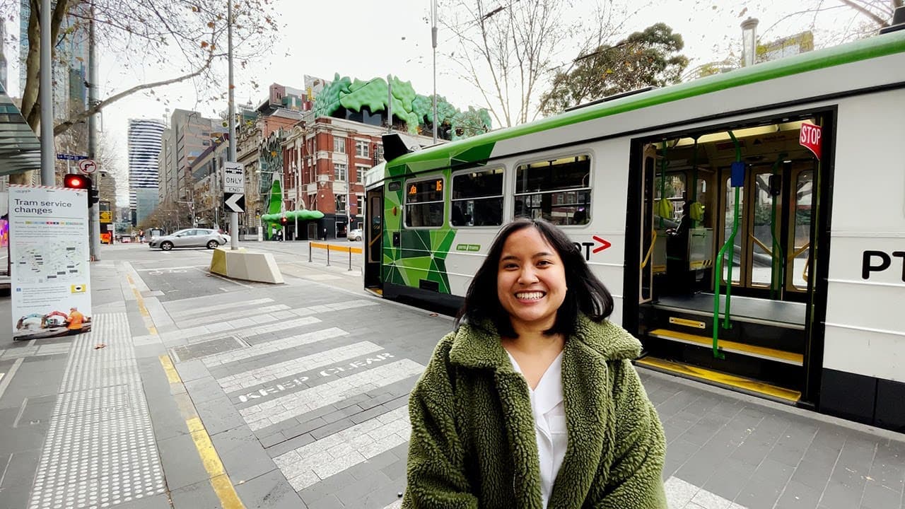 Student in front of a tram
