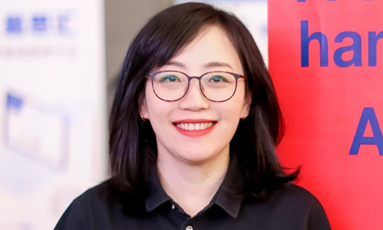 Portrait of Peggy Wang wearing glasses, looking confidently at the camera.