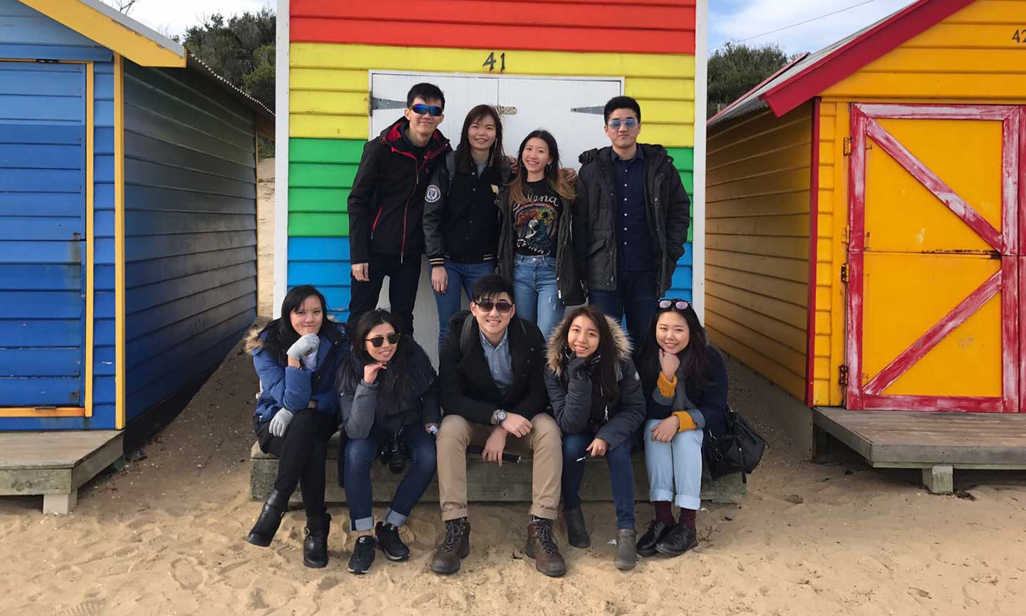 Group of students at beach smiling