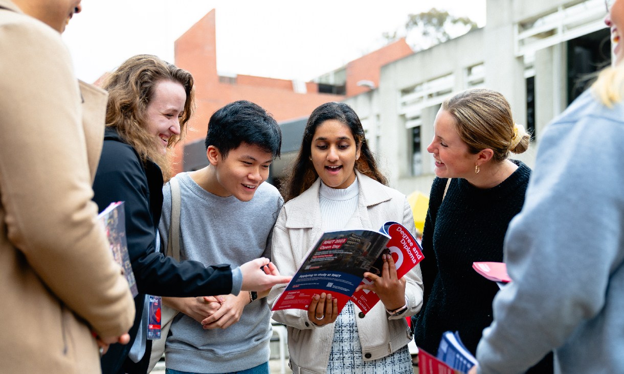 Students exploring RMIT's Bundoora campus using an Open Day guide