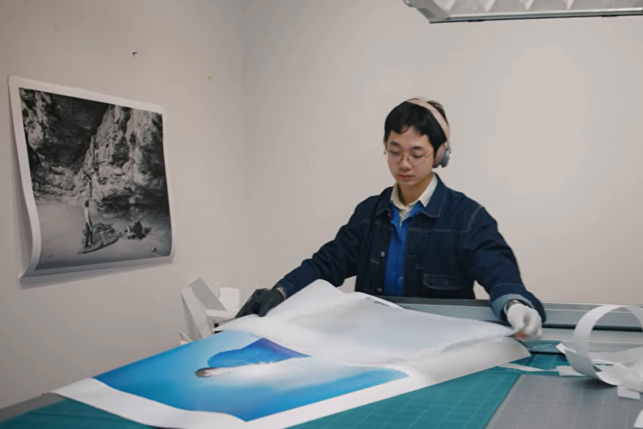 Student reviewing large print photograph on desk