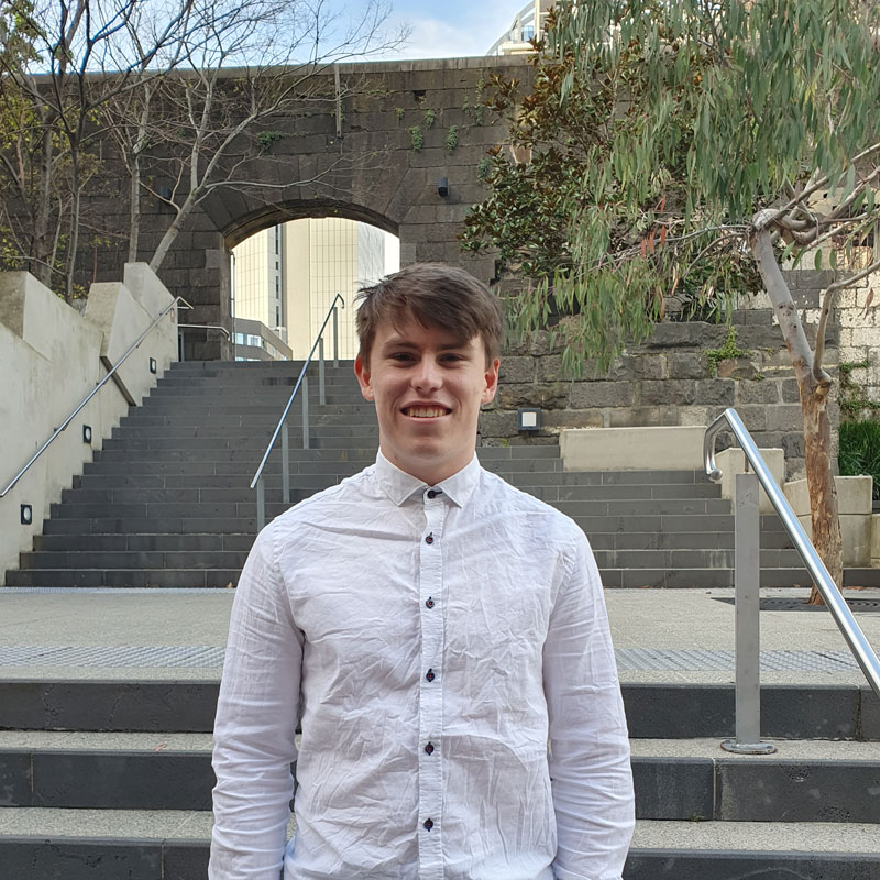 Cooper Maher, Bachelor of Science (Mathematics major) student, smiling on campus