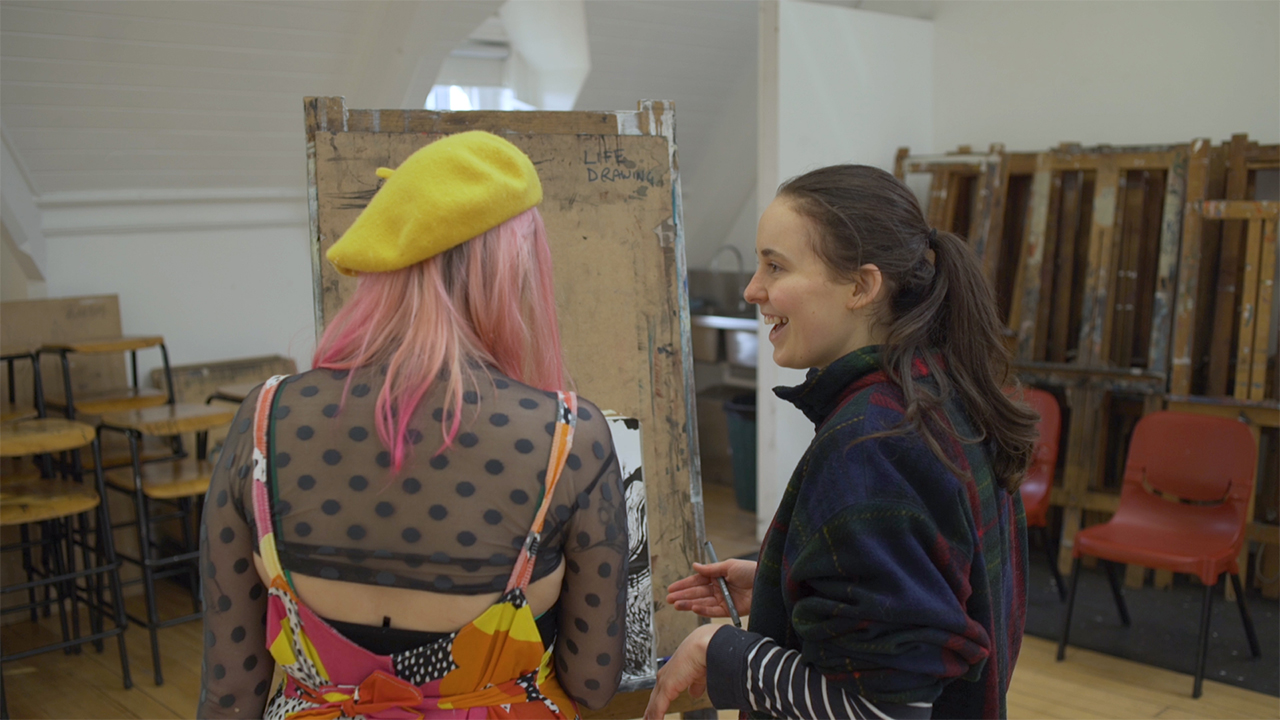 Female art students talking in studio space