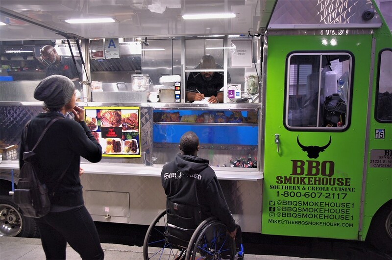 A person using a wheelchair ordering from a food truck