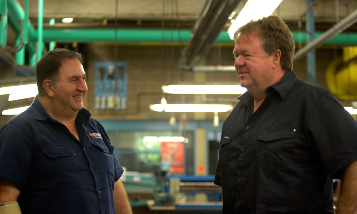 RMIT trainer and Bernard in a plumbing and electrical apprentices work training-area