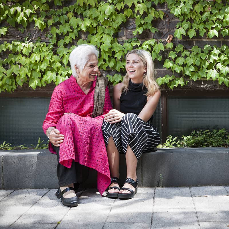 Female RMIT student sitting and laughing with an older woman