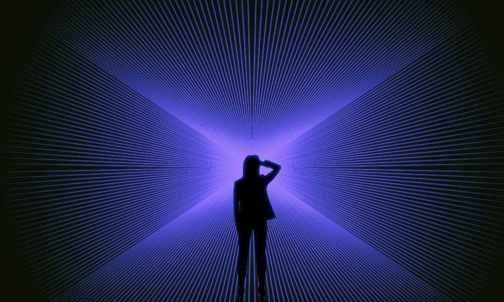 Silhouette of person in front of purple laser beams