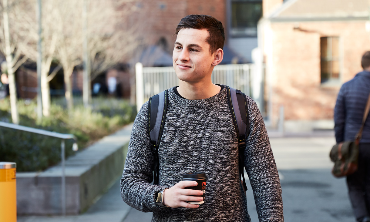 Student Jake Deakin walking through campus