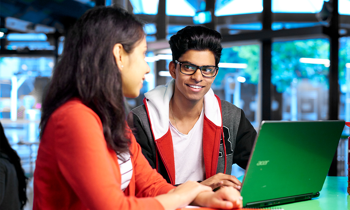 Two student sharing a laptop