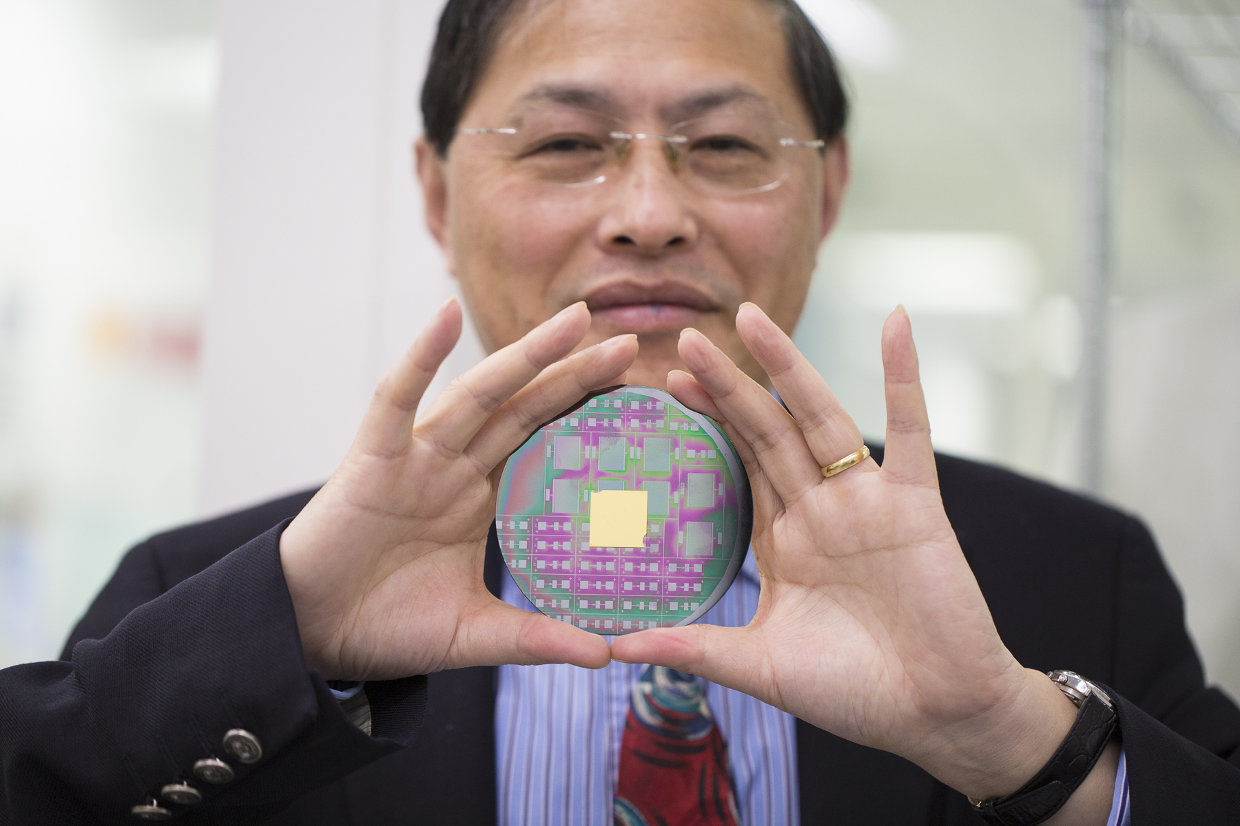 Man holding a nanophotonic chip.