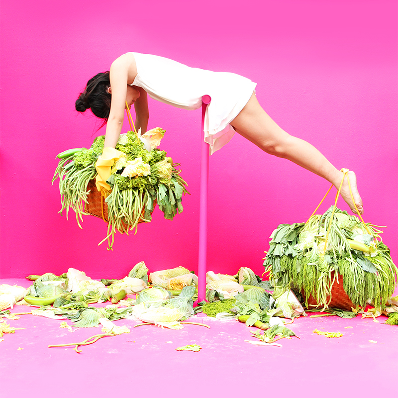 Artwork with bright pink background and woman balanced on a beam imitating the scale of justice