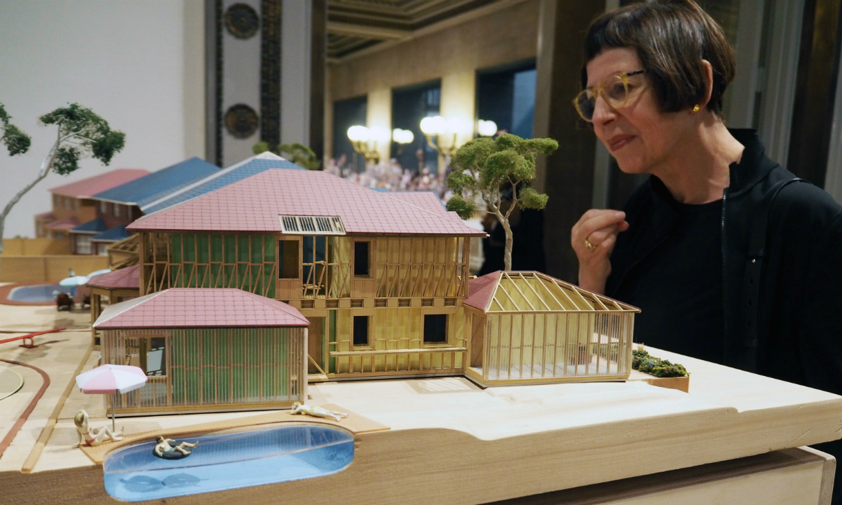 Woman looks at model housing development.
