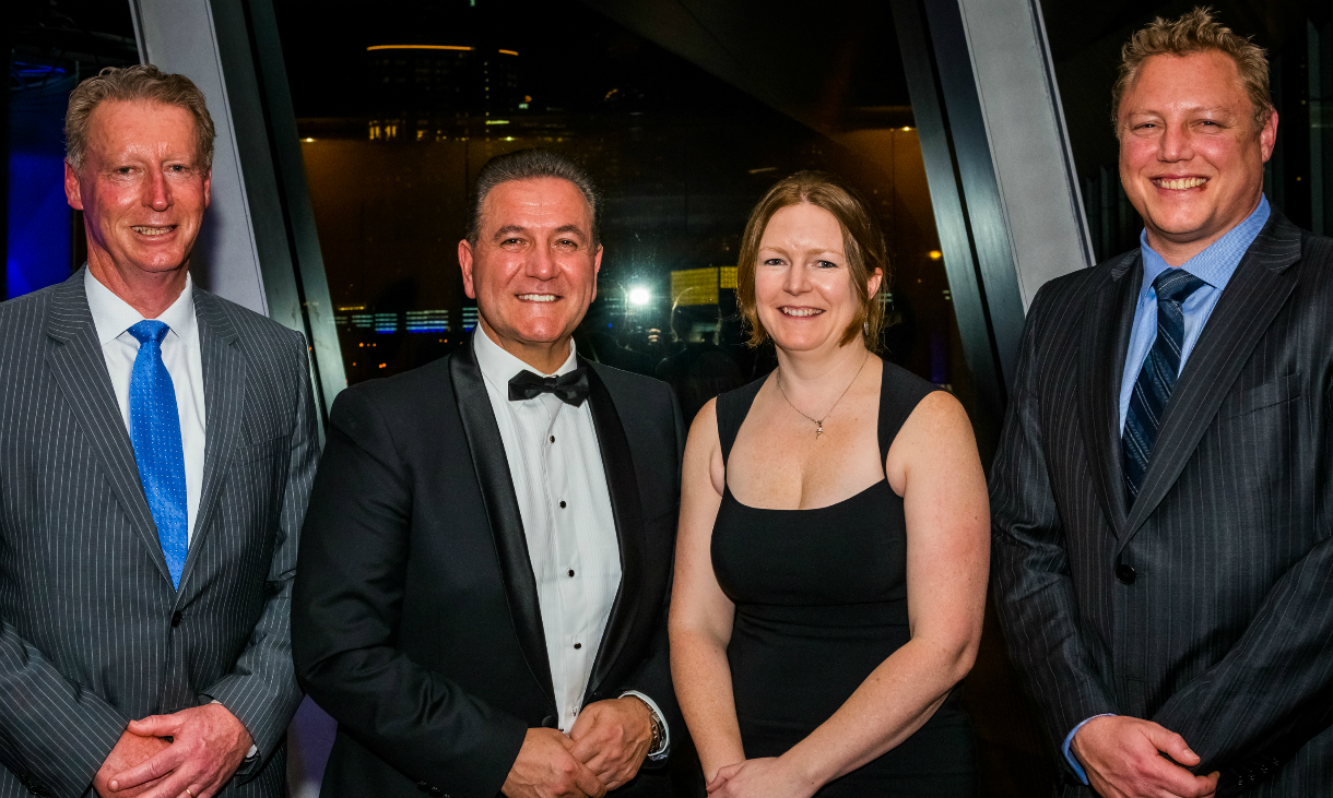Associate Professor Sarah Spencer is congratulated by the Minister for Tourism and Major Events, John Eren, flanked by Melbourne Convention and Exhibition Centre Chief Executive, Peter King (left), and the CEO of Visit Victoria, Peter Bingeman.