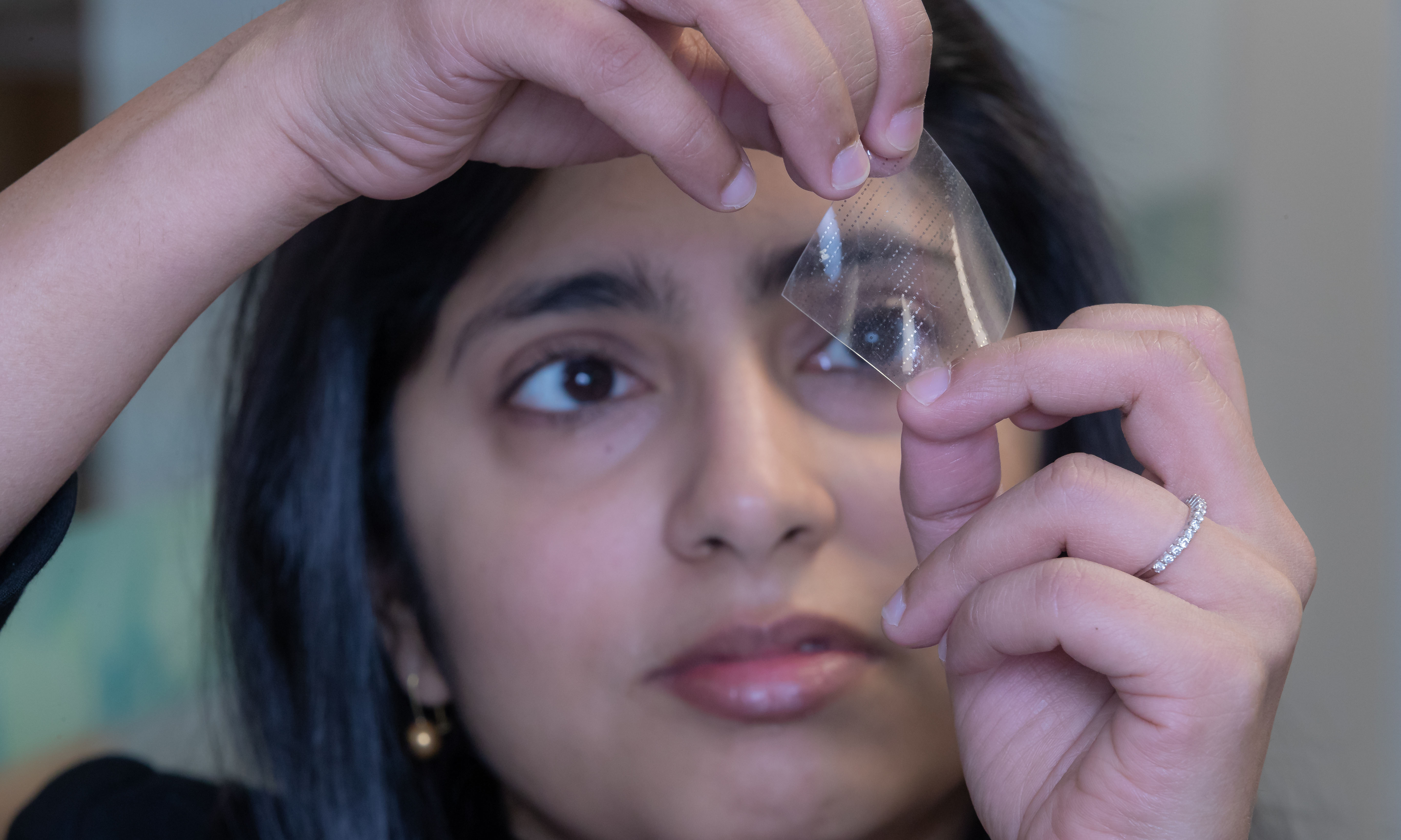 Professor Madhu Bhaskaran holding the flexible sensor technology.