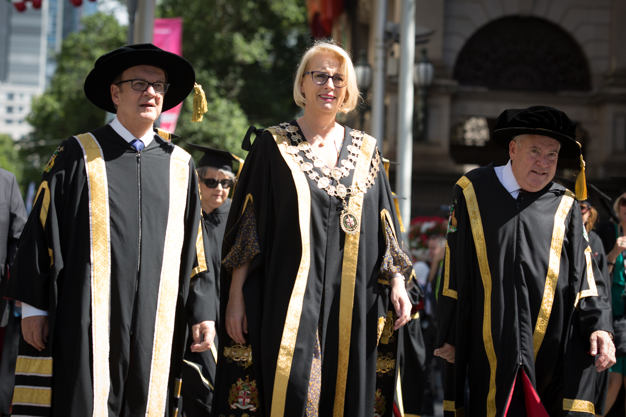 L-R: RMIT Chancellor Ziggy Switkowski AO, City of Melbourne Lord Mayor Sally Capp and RMIT Vice-Chancellor and President Martin Bean CBE walk together following the iconic RMIT graduand parade