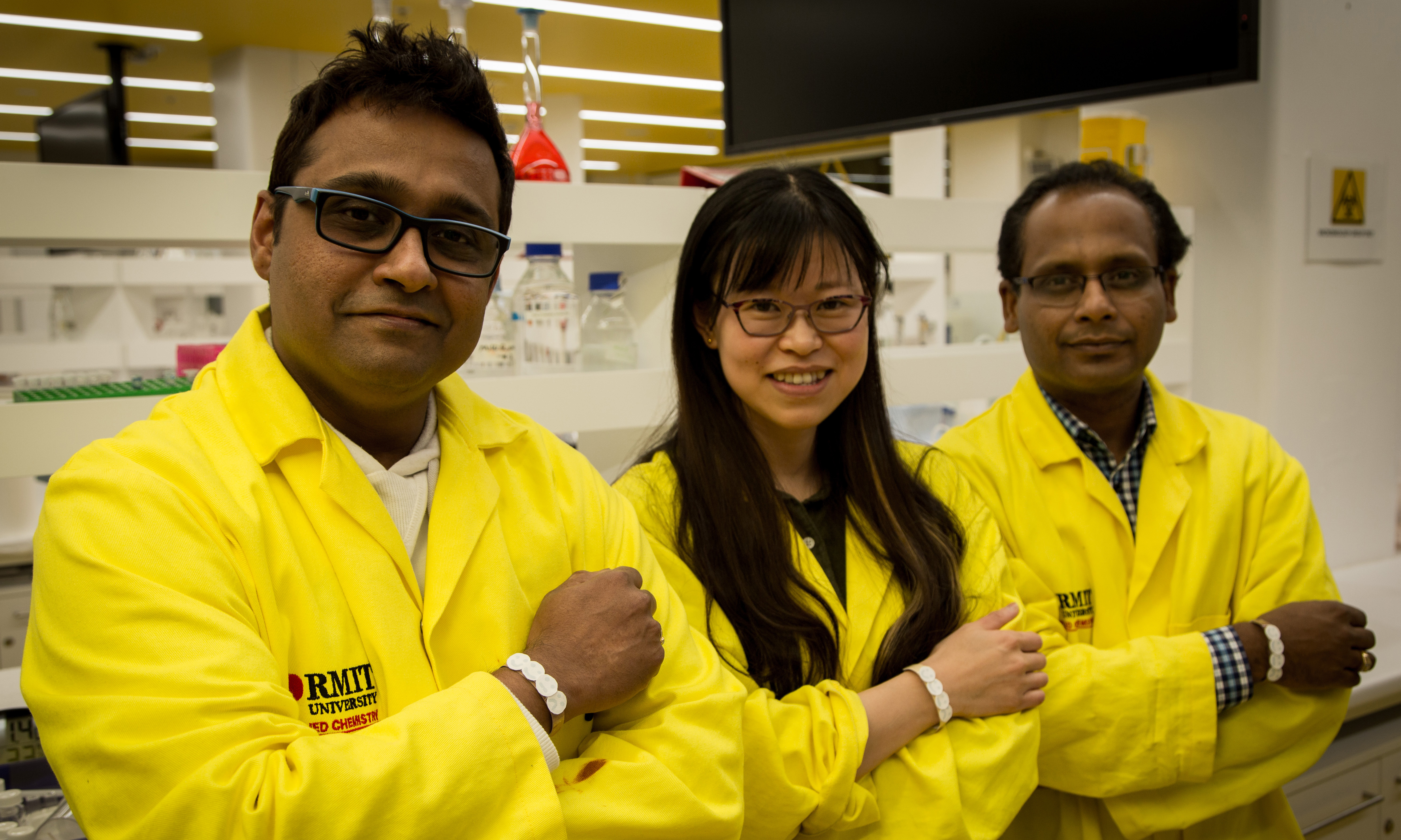 RMIT researchers from the Ian Potter NanoBioSensing Facility wearing prototypes of their UV sensor, from left to right, Dr Rajesh Ramanthan, Dr Wenyue Zou and Professor Vipul Bansal. Credit: RMIT University