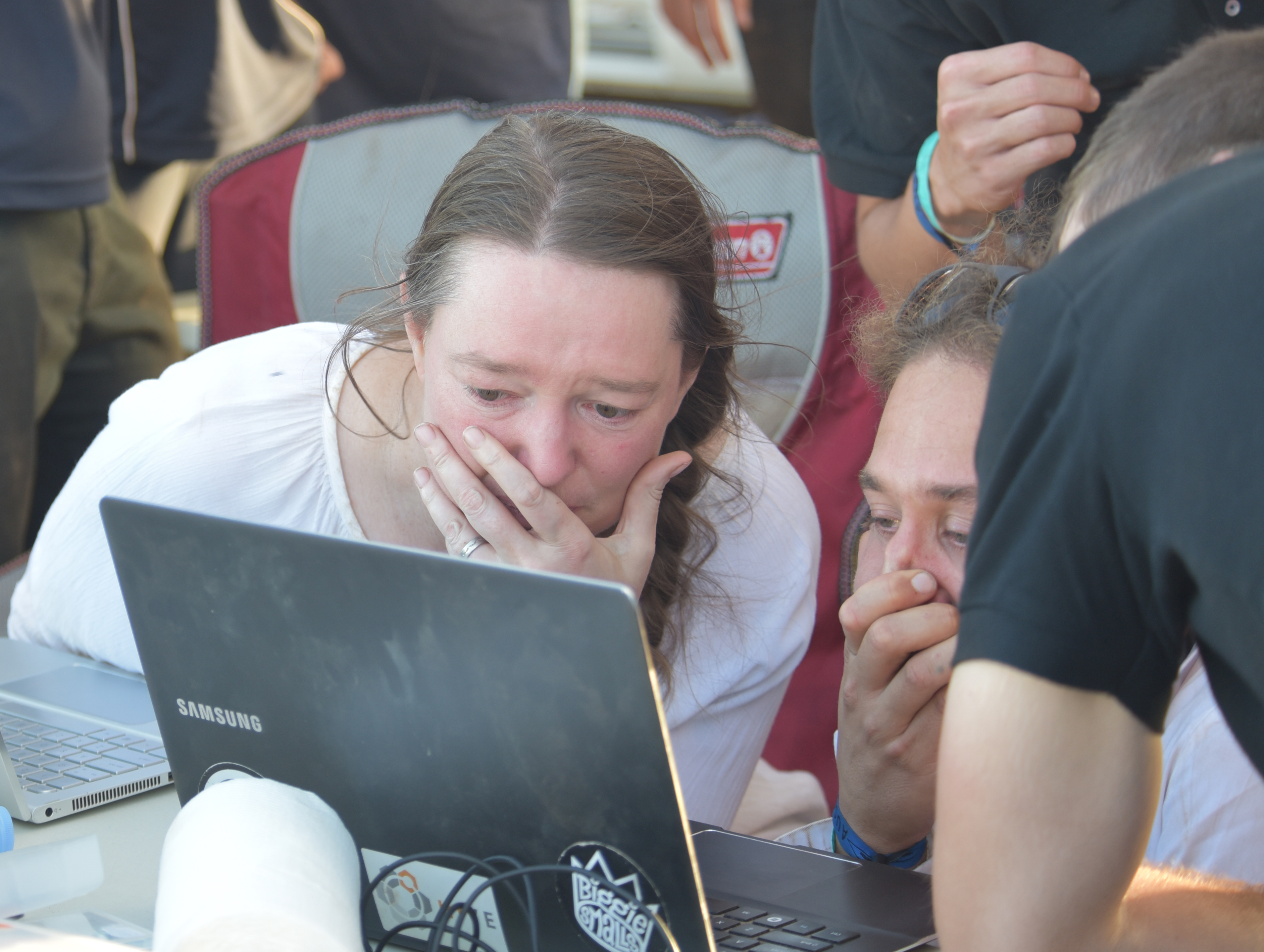 Emotional team members watch the winning launch.