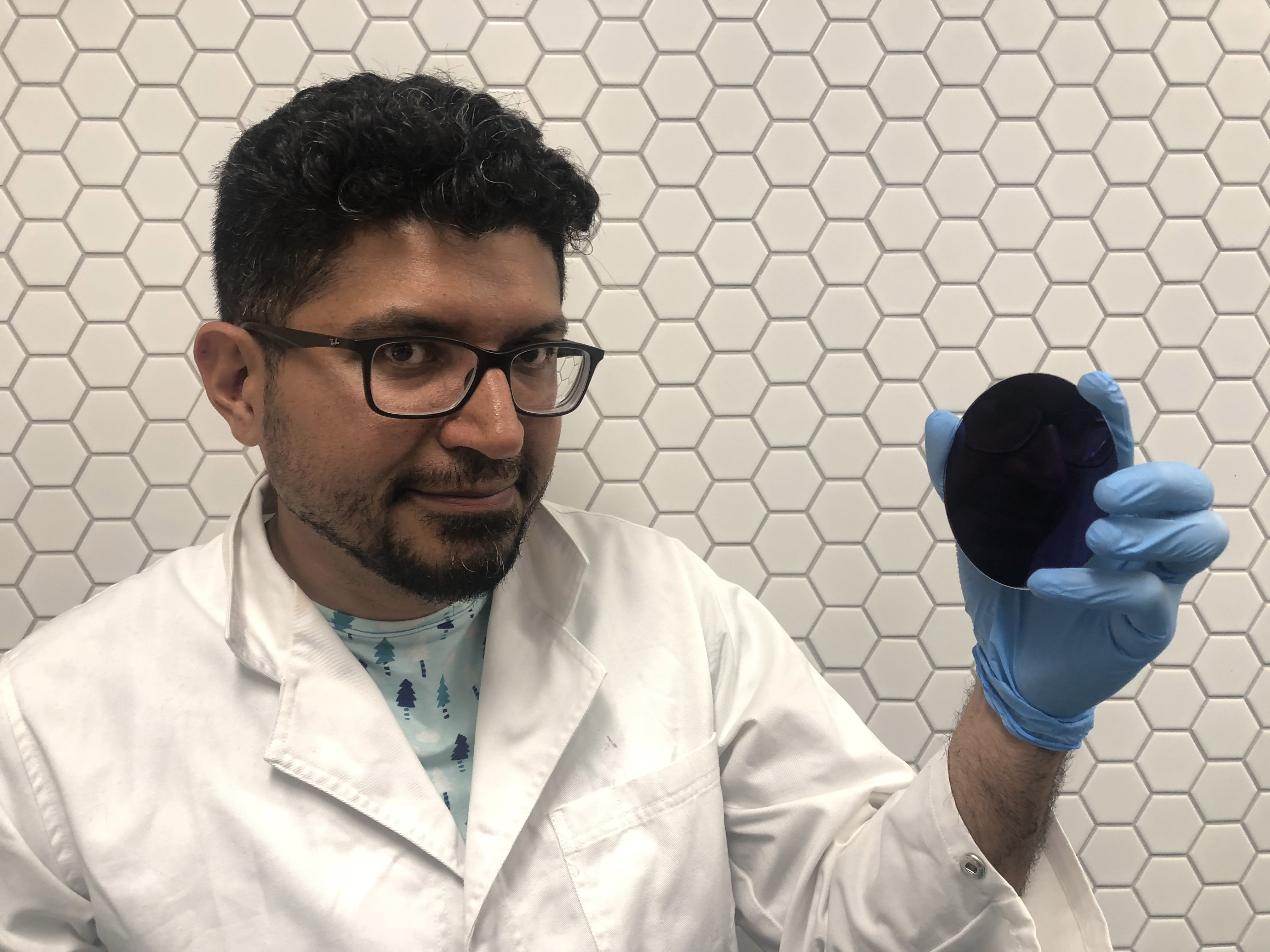 ARC Future Fellow, Associate Professor Daniel Gomez, holding a disc covered in the nano-enhanced palladium.