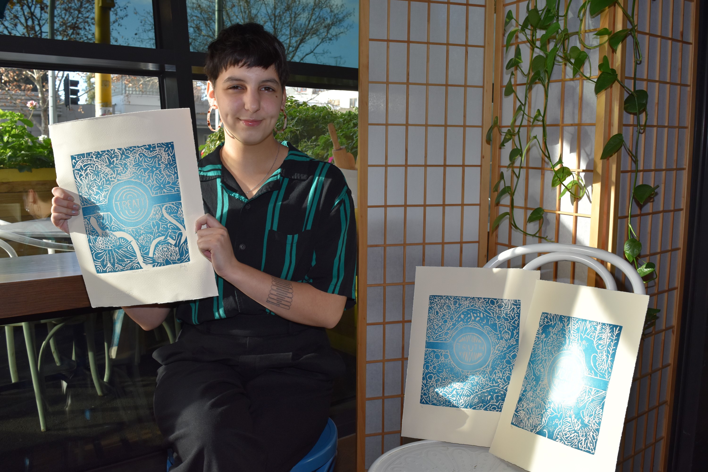 Student Eleanor Franks proudly displays her NAIDOC Week artworks