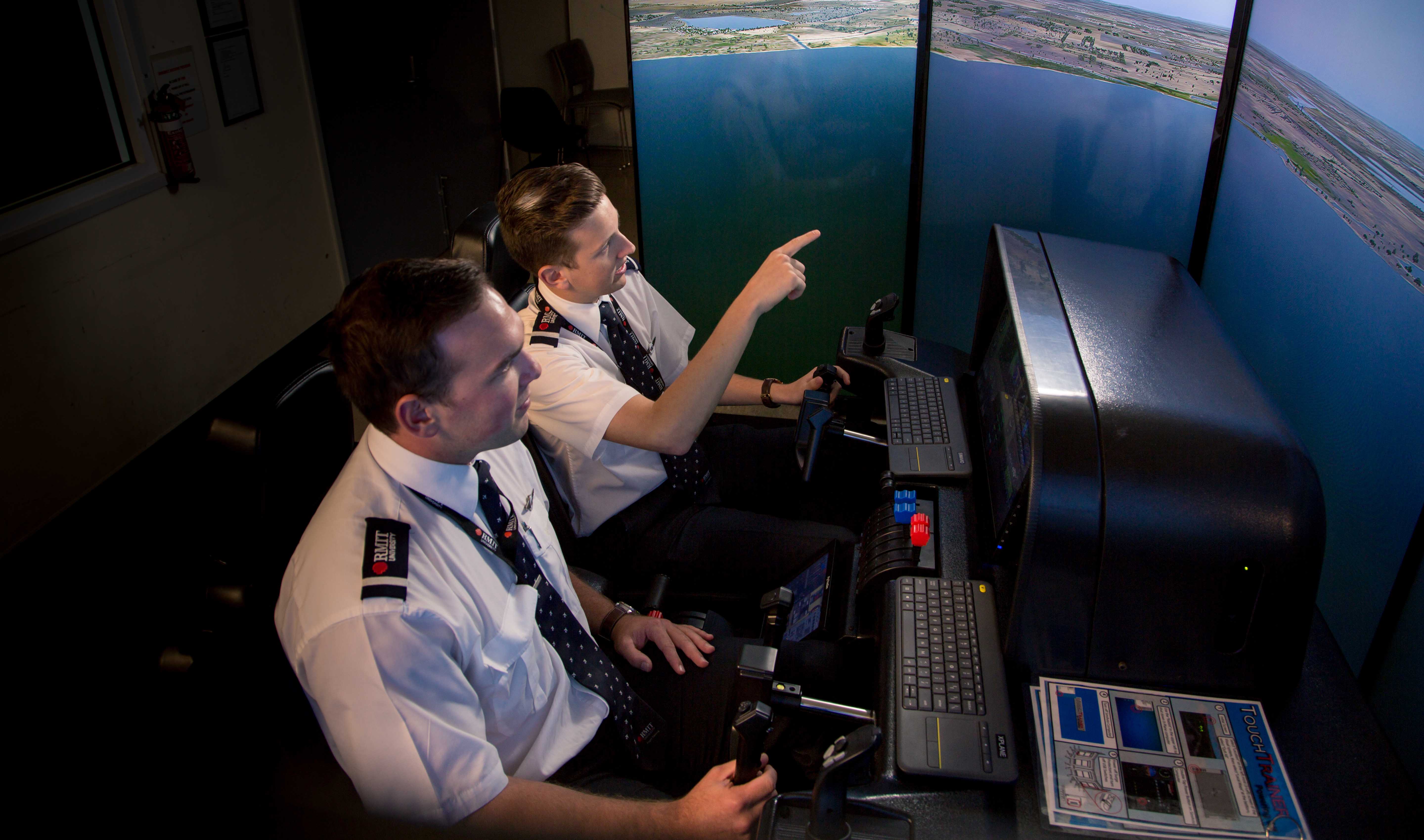Two RMIT pilots in the brand new flight training simulator