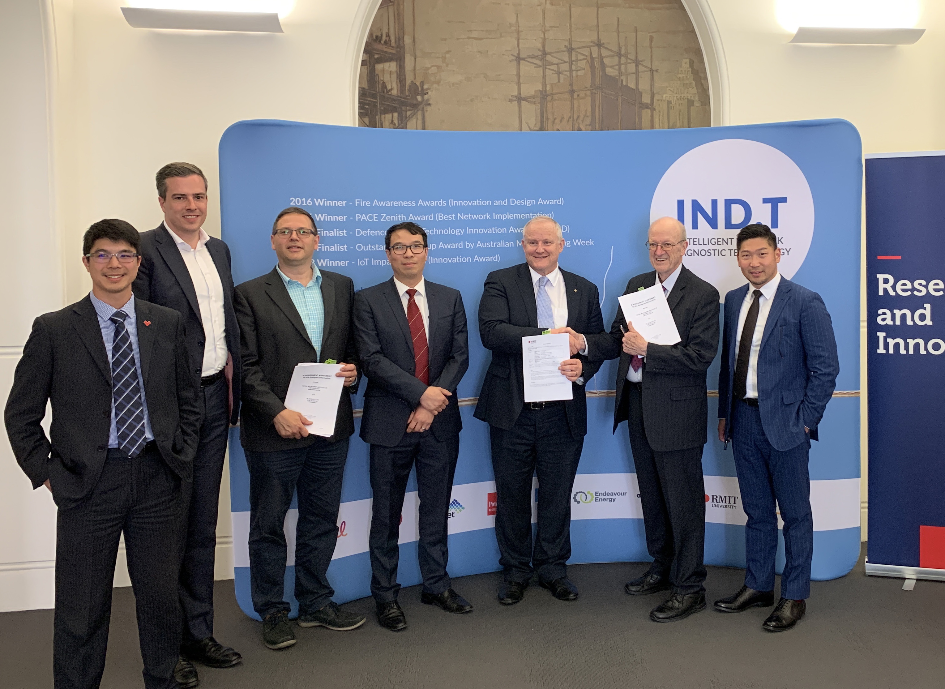 RMIT's Deputy Vice-Chancellor Research and Innovation Professor Calum Drummond shakes hands with IND Technology Chairman Dr Tony Marxsen after signing the agreement.