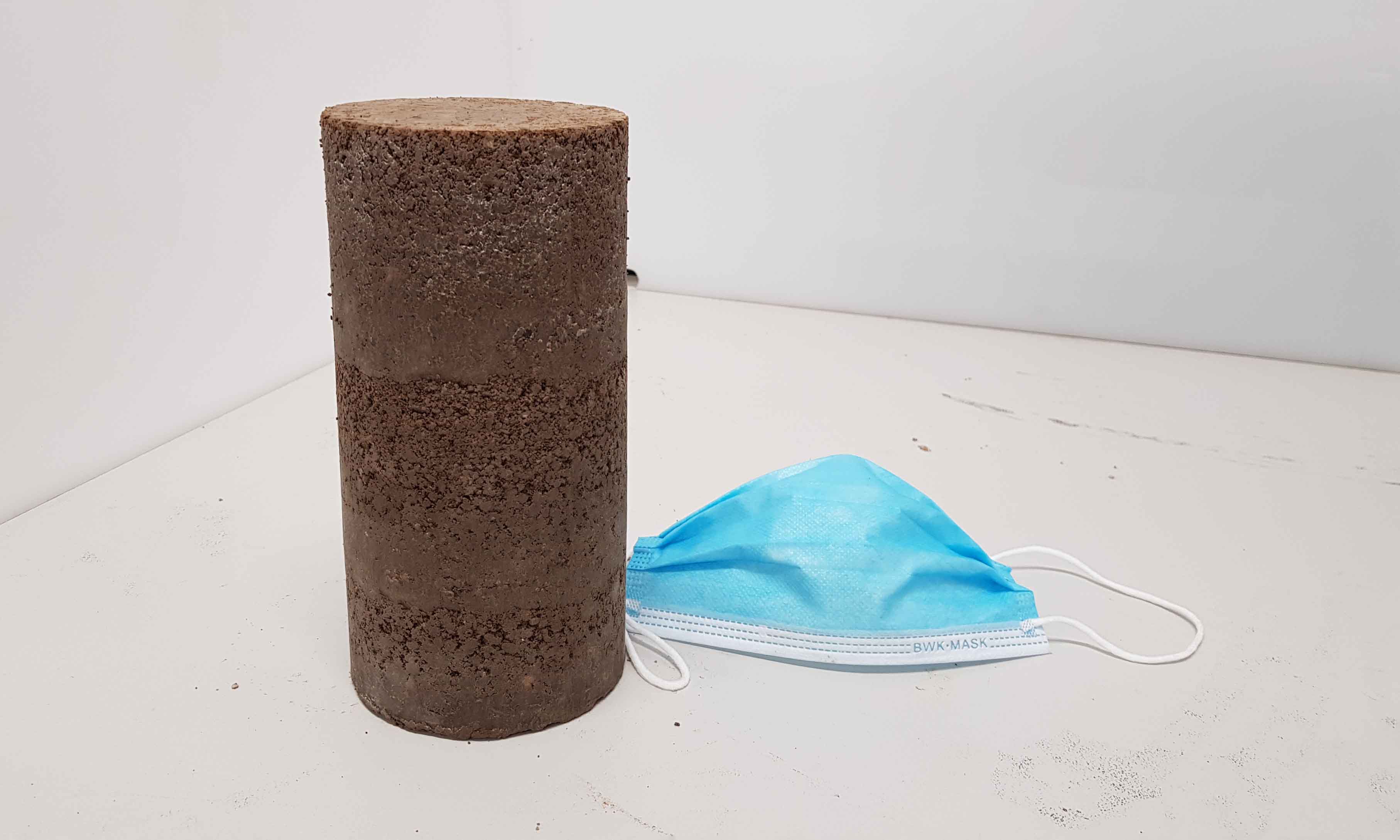 A sample of the recycled road-making material, next to a single-use face mask