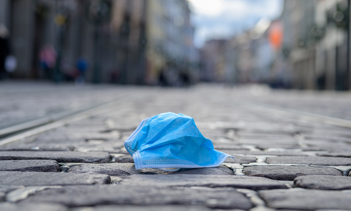 Face mask on the ground. Credit: Adobe Stock